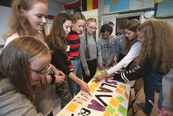 Leerlingen van klas 2B plakken steunbetuigingen voor Yaroslava Tymts (midden, met vlechten en bril) op een spandoek. FOTO: NIELS WESTRA